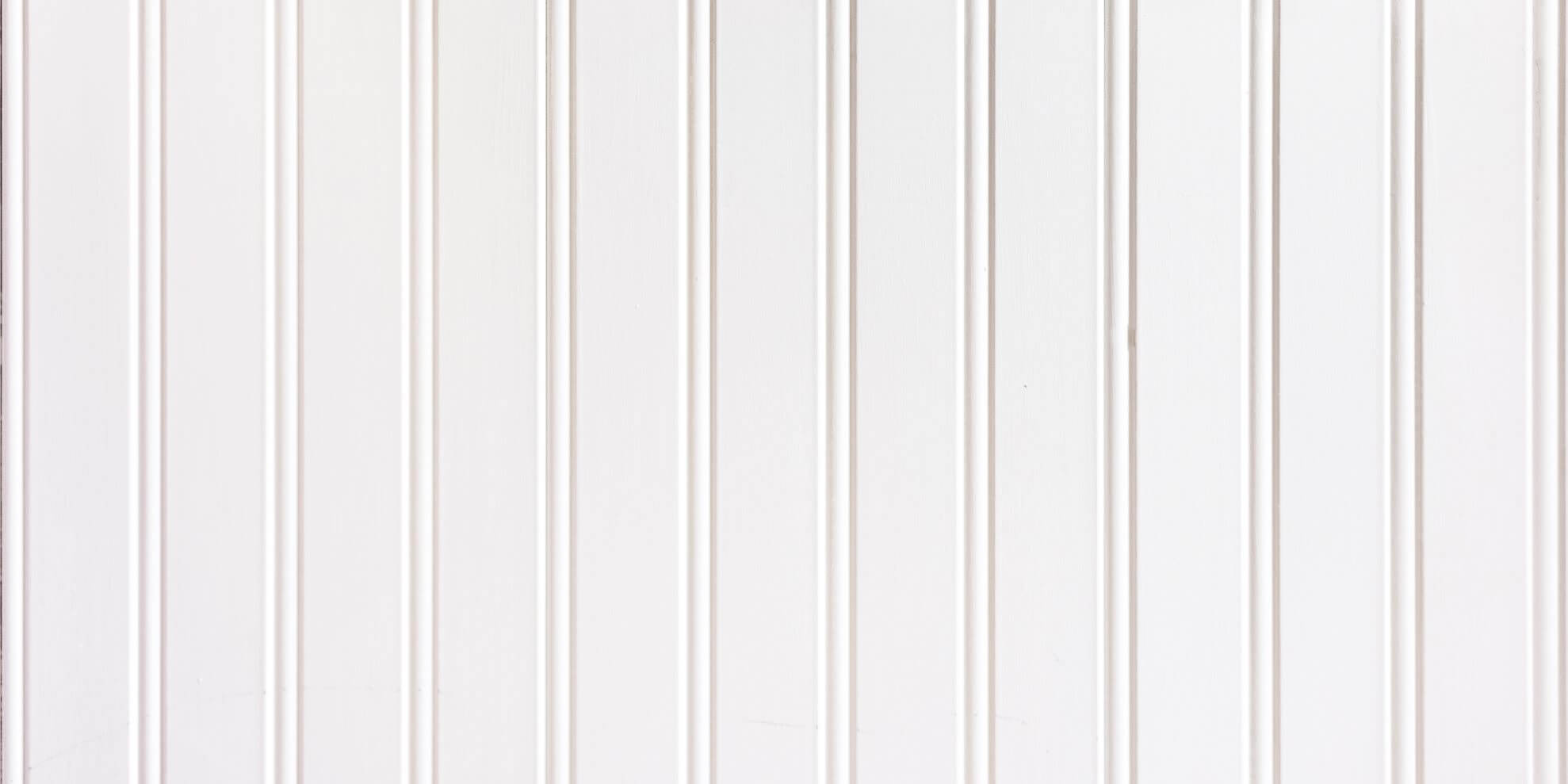 Beadboard Paneling painted white with one and one half inch between the beads